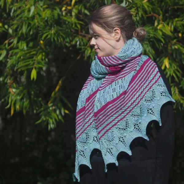 Woman wearing a seafoam and magenta lace wrap