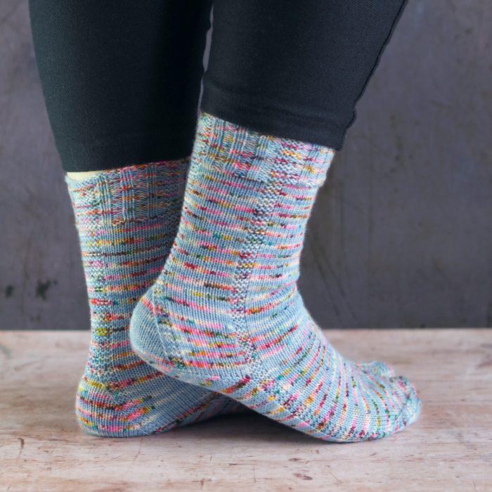 blue speckled duet sock with strong heel and garter column