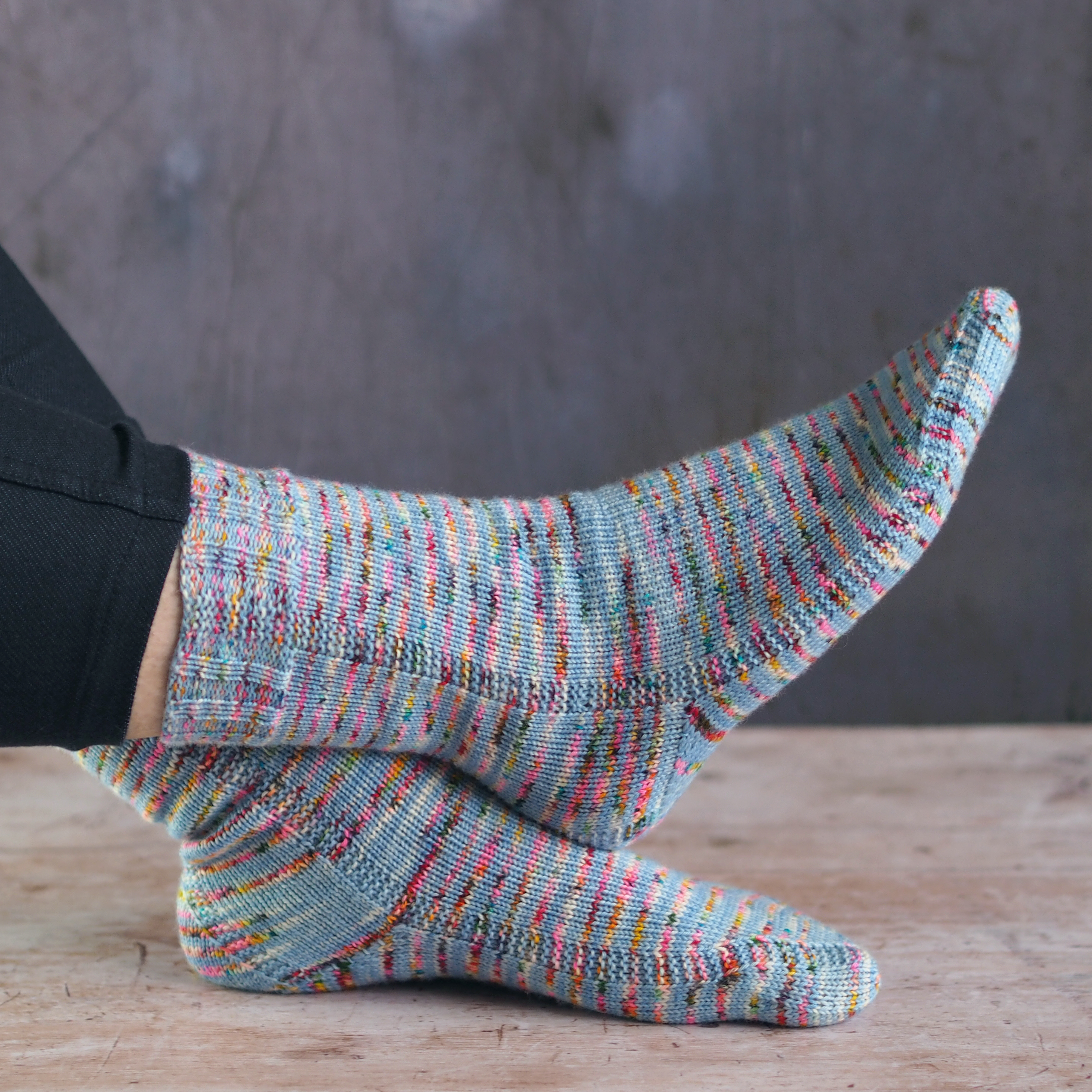 duet socks in light blue speckled yarn with strong heel and garter columns