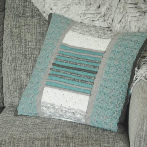 Blue, grey and cream knitted cushion cover with texture