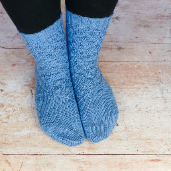 from above mid blue texture sock with diagonal band across arch
